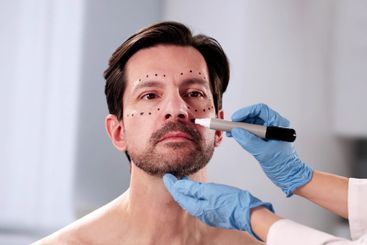 Male patient receiving cosmetic plastic surgery