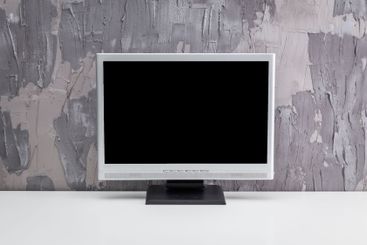 Empty desktop monitor standing on a minimalistic white...