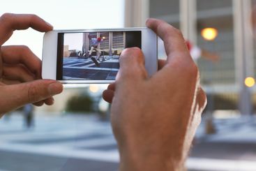 Person, hands and skateboard with phone screen or camera...