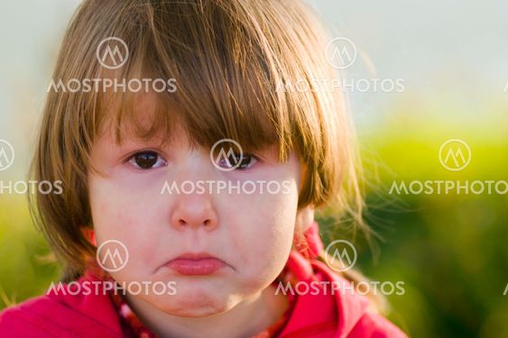 crying little girl looking at you