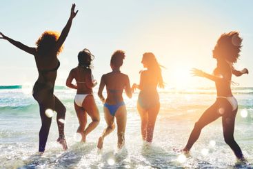 Women, friends and freedom in ocean for travel, excited...