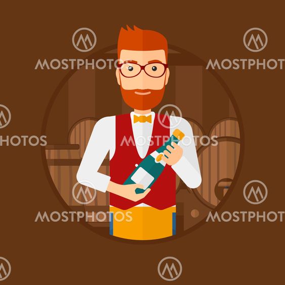 Waiter holding bottle in wine cellar.
