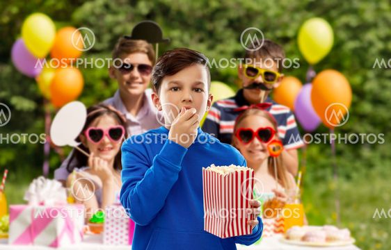 boy eating popcorn at birthday party