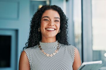 Happy, confident and portrait of businesswoman in office...