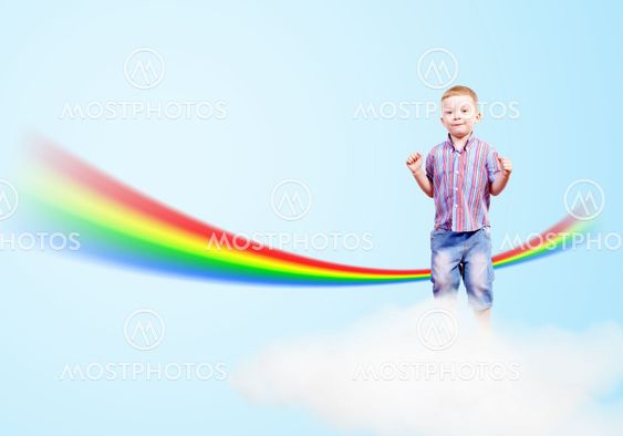 boy jumping on clouds and a rainbow