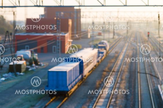 Blurred image of cargo train platform against sunrise