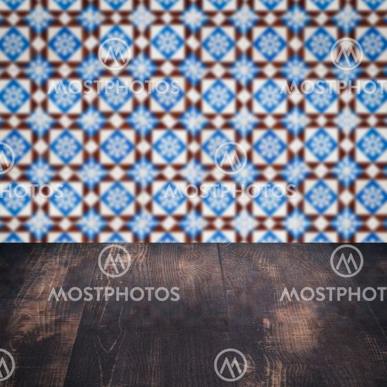 Wood table top and blur vintage ceramic tile pattern wall