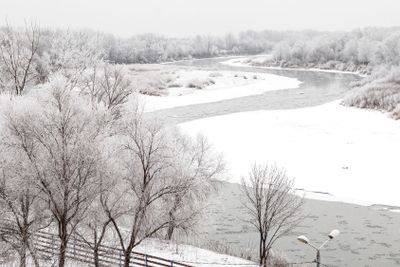 Winter landscape of a white snowy shore of a river....