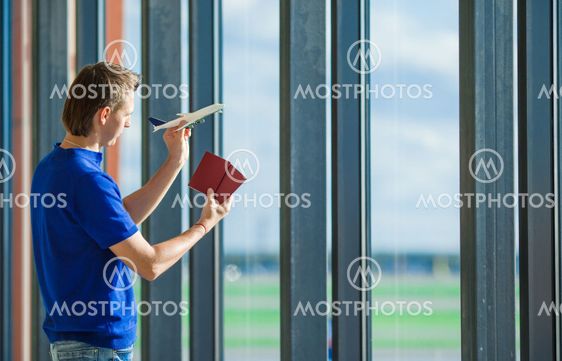 Young caucasian man holding passports and boarding pass...