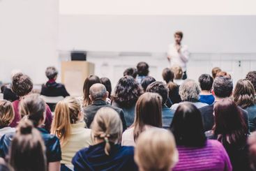 Woman giving presentation on business conference event.