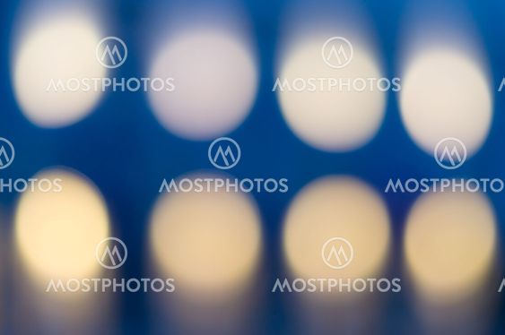 Defocused background with two rows of circular bokeh lights