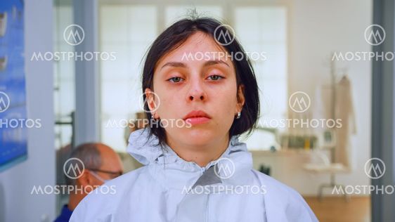 Exhausted nurse looking on camera without face mask