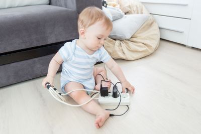 Adorable baby playing with electrical extension and wires...