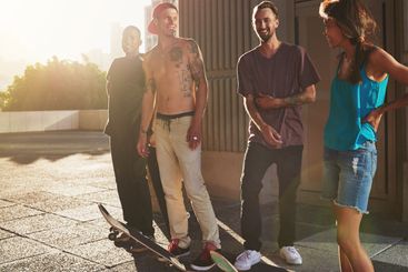 Smile, people and skateboard with fitness in city for...