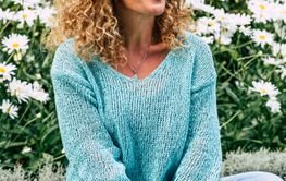 One woman enjoying outdoor park sitting on the grass and...