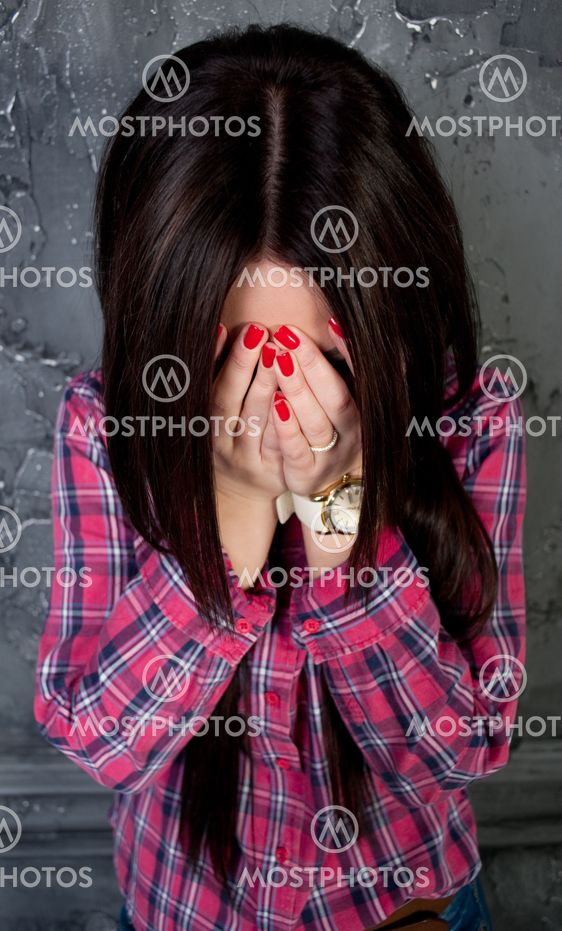 The young Girl shut the face with the hands