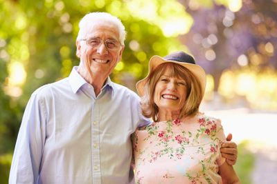 Portrait Of Senior Couple On Walk In Countryside Together