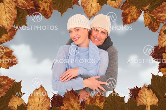 Composite image of casual couple in warm clothing