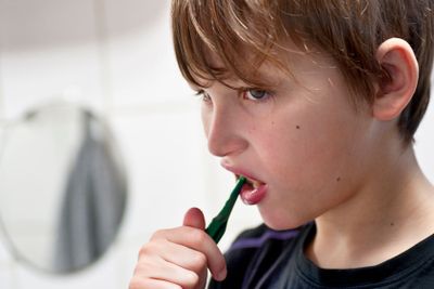 Young boy brushing teeth