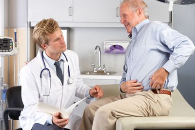 Doctor Examining Male Patient With Hip Pain
