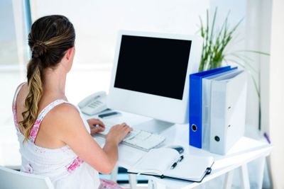 pregnant business woman typing on her computer