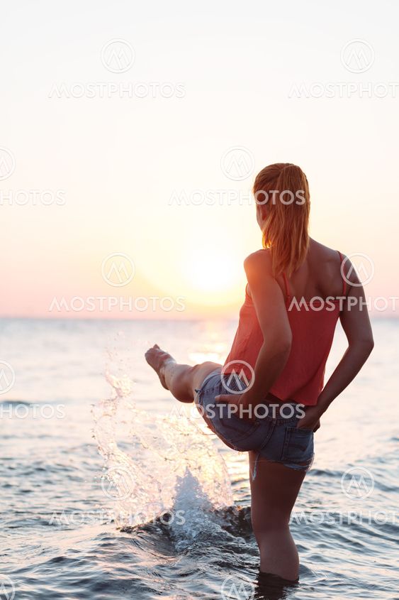 Young woman enjoying sea and sunset