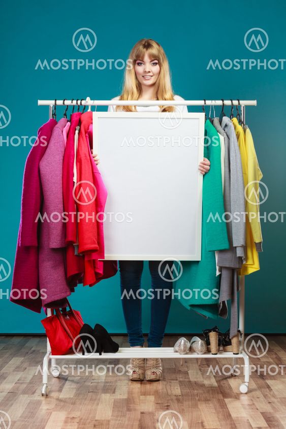 Woman in mall wardrobe with blank banner copyspace