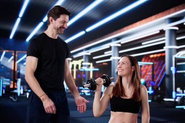 Strong Female Athlete Gets Motivation From Personal Trainer