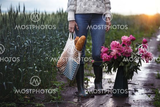 girl with a bouquet of flowers walking on a road