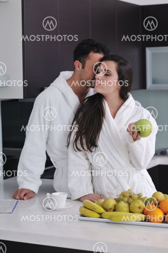 young couple have fun in modern kitchen