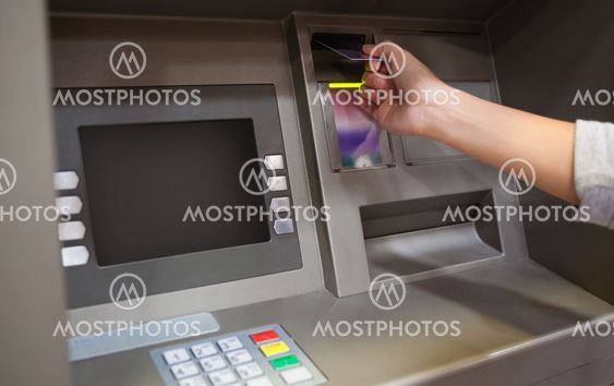 Hand inserting a credit card