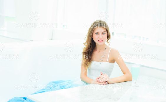 Portrait of a cute woman in a city cafe