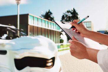 African American Car Insurance Agent Inspecting Accident
