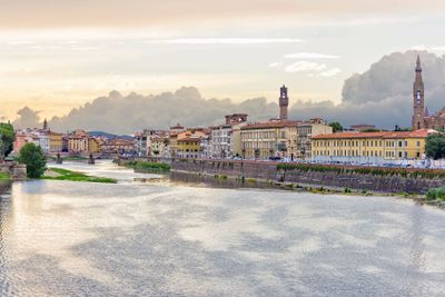 Daylight view to sunset above Arno river with reflections