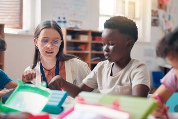 Writing, education and educator helping children in...