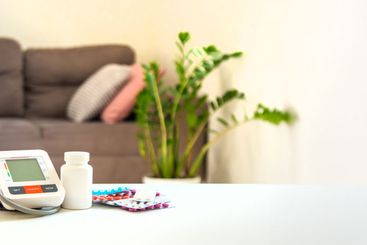 An old woman measures her blood pressure. Selective focus.