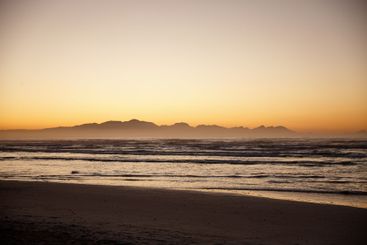 Waves, sunset and horizon of calm beach, nature and...