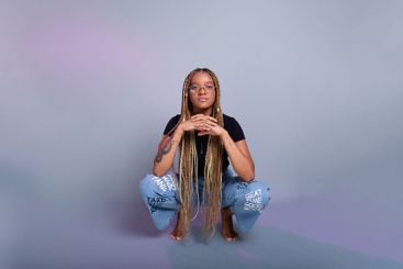 Brunette model with braids in her hair, wearing...