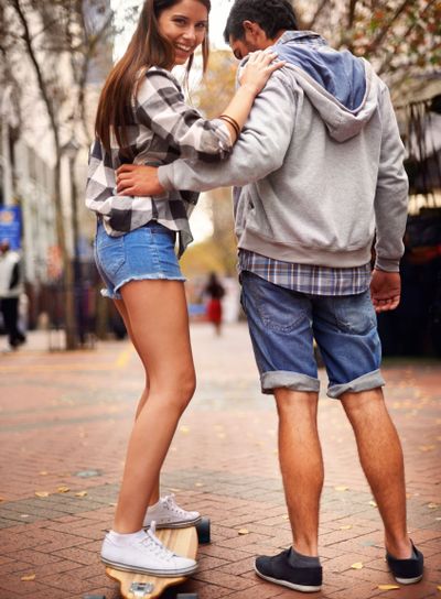 Couple, skateboarding and outdoor in city, happy and...
