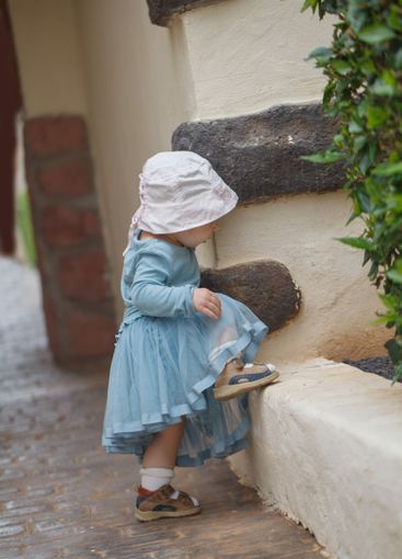 Walking little child girl outdoors. Childhood