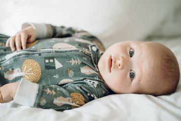 Cute, toddler and portrait of a baby on a bed for...