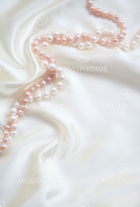White silk with white and pink pearls as wedding background