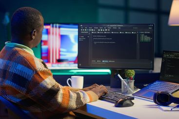 Programmer in home office concentrating on finding bugs...