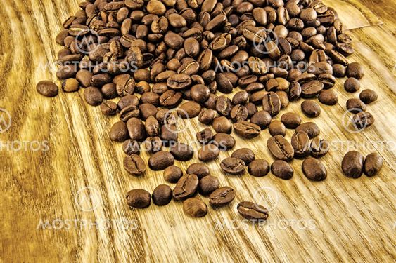 Coffee beans on vintage wooden board