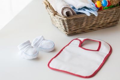 close up of baby bootees, bib and newborn stuff