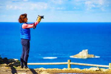 Tourist with camera on Asturias coast, Spain