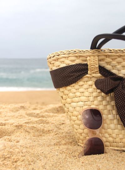 Seacoast, straw beach bag and sunglasses 	