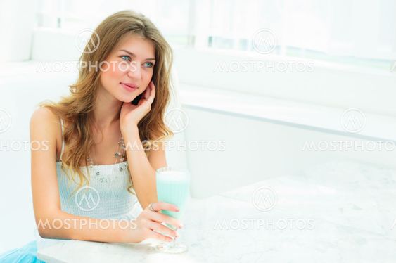 Portrait of a cute woman in a city cafe