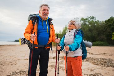 Hiking tourism adventure. Senior couple man woman...