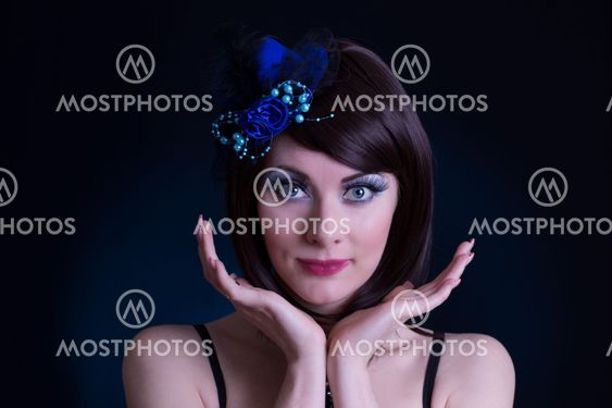 Doll like woman with blue hat and long lashes